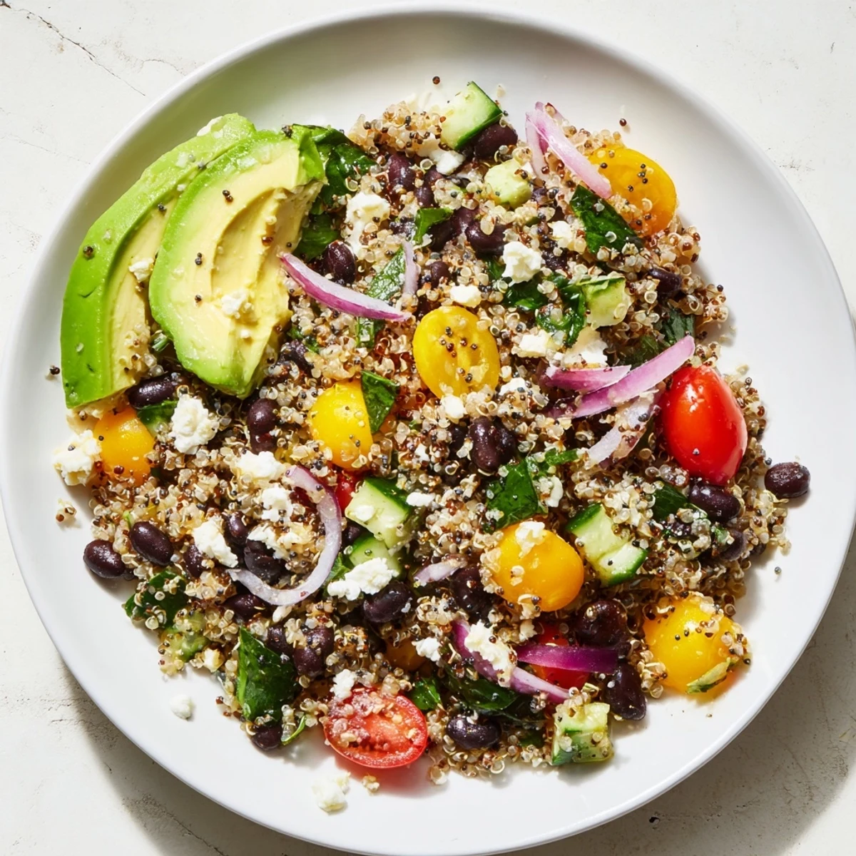 A beautiful bowl of Poppy-Bright Colorful Quinoa and Black Bean Salad bursting with fresh veggies.