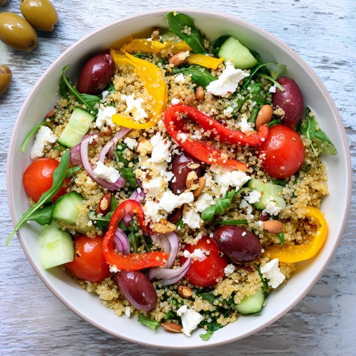 Fluffy quinoa and vibrant veggies combine in this delicious Mediterranean Grain Bowl served in bowls.