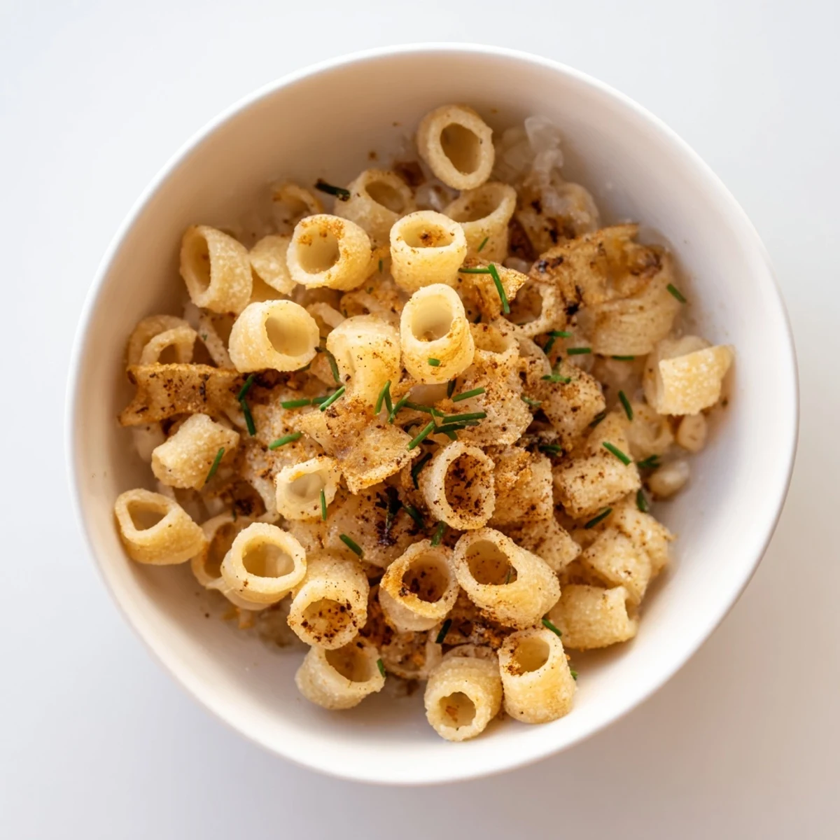 Savor the savory aroma of Pasta Chip Cereal, a fun appetizer featuring umami parmesan broth.