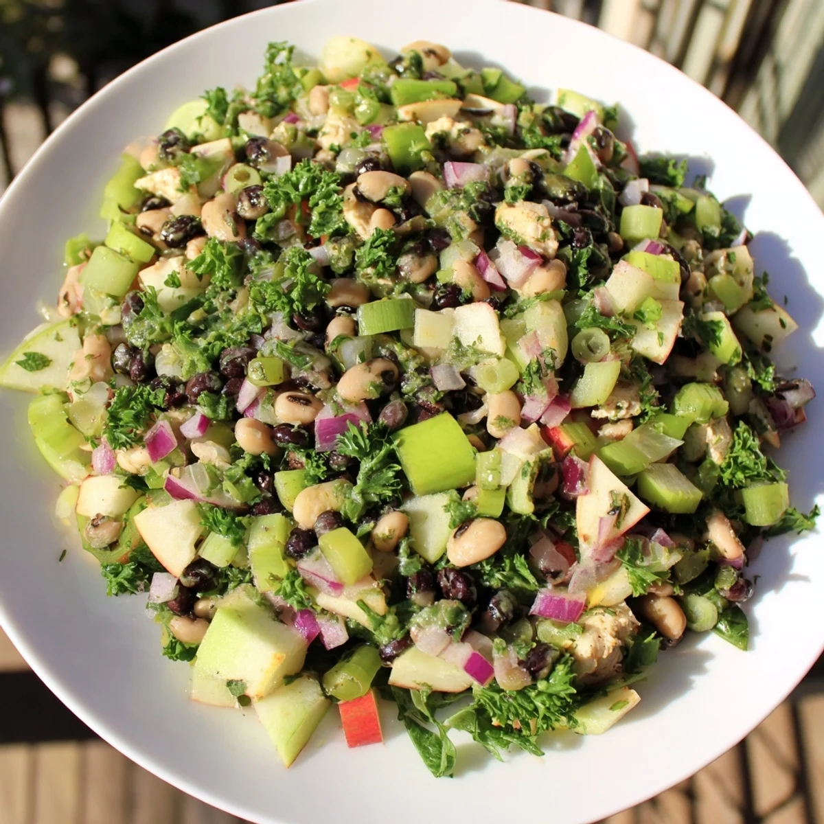 Fresh, vibrant Chicken and Apple New Years Luck Salad, showing mixed greens and diced fruit, ready to serve.