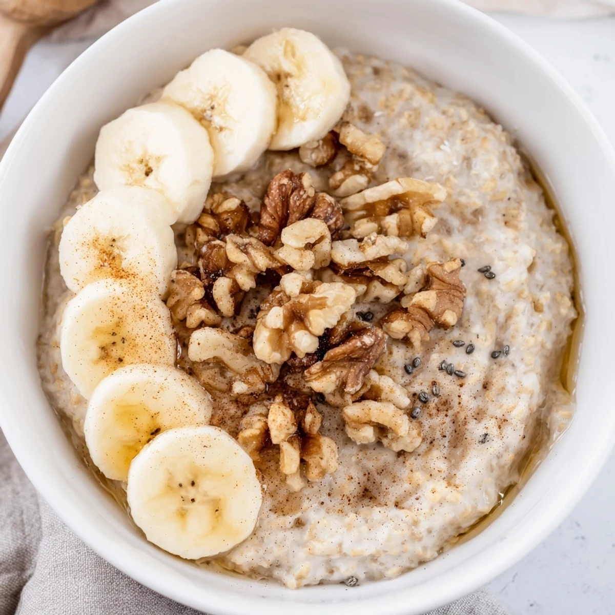 Steaming, creamy Microwave Banana Oats, garnished with fresh banana slices, ready for a warm breakfast.