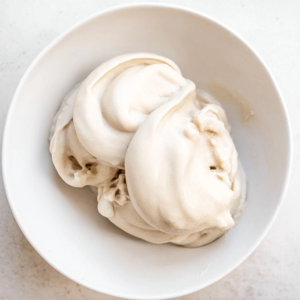 Frozen banana coins transformed into delicious, simple 2-Ingredient Banana Ice Cream with milk.