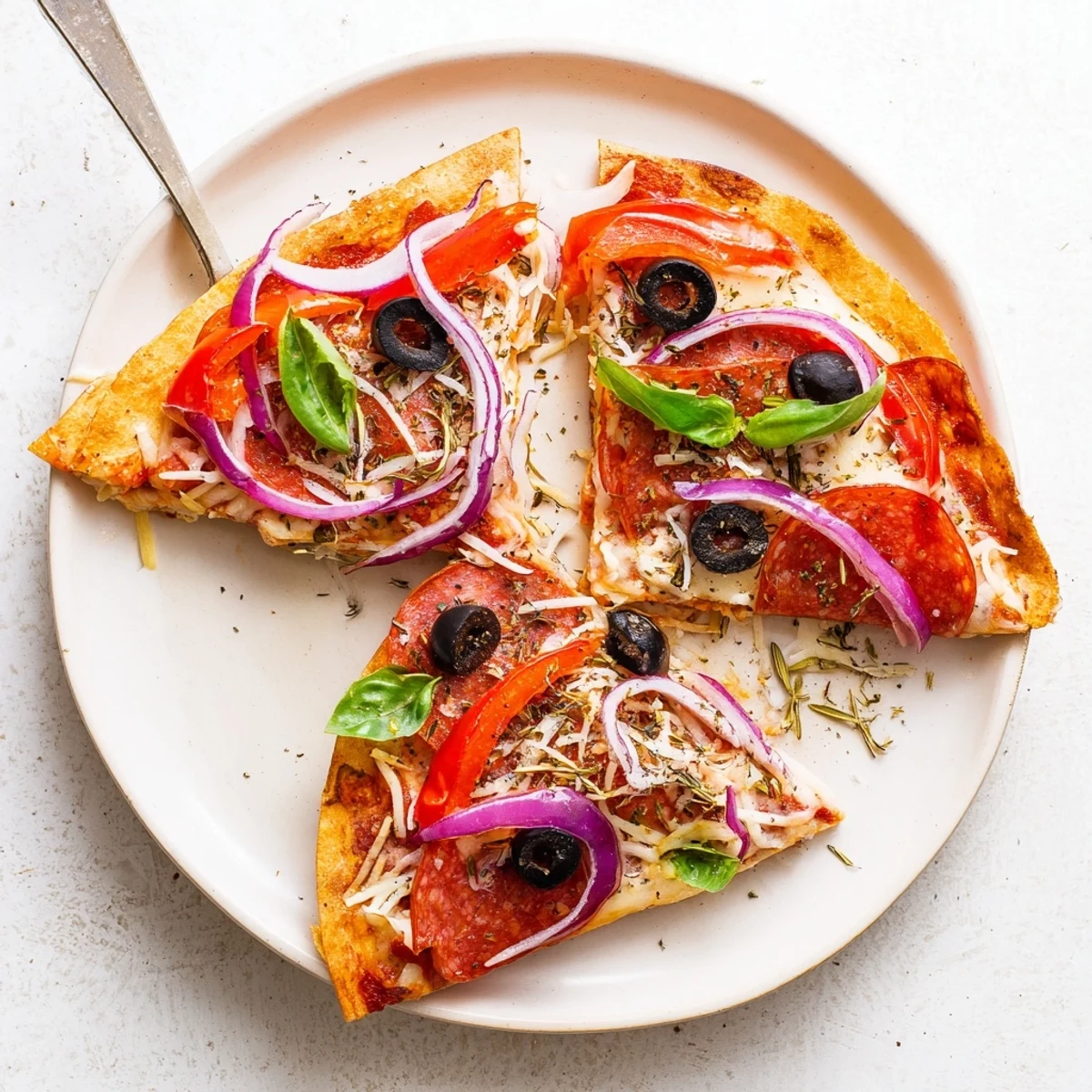 Crispy golden tortilla pizza wrap fresh from the skillet, showing melted mozzarella and vibrant toppings.  