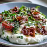 A vibrant honey peach burrata toast with golden sourdough, creamy cheese, and juicy peaches for a fresh spring brunch.