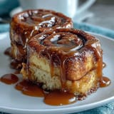Decadent cinnamon roll pancake casserole baked golden, swirled with cinnamon sugar, and topped with a luscious cream cheese glaze.