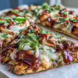Gooey BBQ chicken flatbread pizza loaded with red onion, bell peppers, and jalapeño for a spicy kick.  