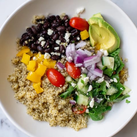 Vibrant Poppy-Bright Colorful Quinoa and Black Bean Salad, a colorful vegetarian meal with zesty dressing.