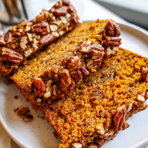 A close-up of a rustic Weekend Cabin-Style Sweet Potato and Pecan Loaf with visible pecan pieces.