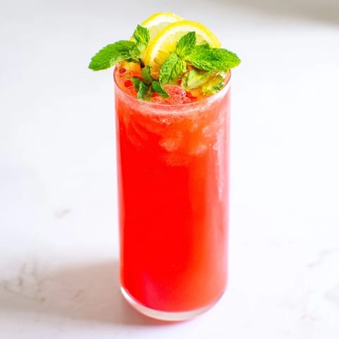 Bright, homemade fruit refresher drinks, chilled and glistening with ice, perfect for a hot day.