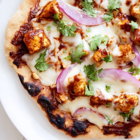 Freshly baked BBQ Chicken Flatbread with melted mozzarella and tangy BBQ sauce drizzle.