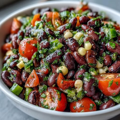 Freshly prepared Cowboy Caviar served with crispy tortilla chips, perfect for a Tex-Mex party appetizer.