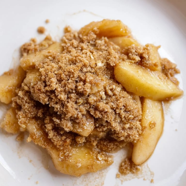 A close-up shot of the delicious Spiced Apple Crisp, topped with a soft, buttery crumb.