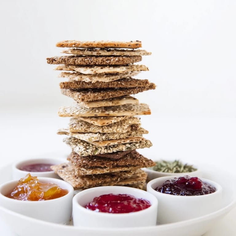 A mouthwatering view of Gourmet Crackers stacked high, ready to pair with cheese boards and jams.