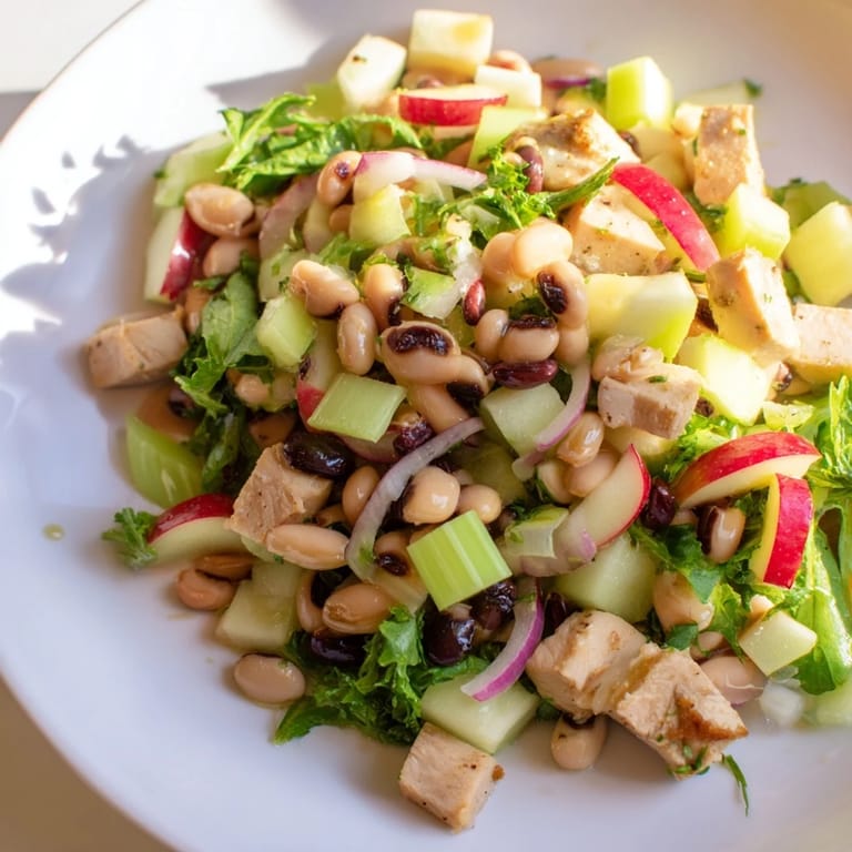 This Chicken and Apple New Years Luck Salad includes savory chicken with black-eyed peas topped with toasted pecans.
