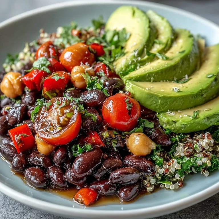 A close-up of the Three-Bean Power Bowl reveals chickpeas, kidney beans, and black beans mixed with quinoa, garnished with fresh cilantro.